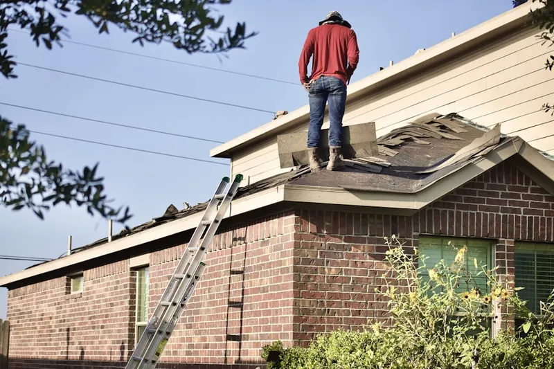 Professional roofer working on a residential roof in Dunes West